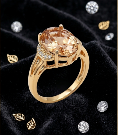 Champagne oval statement ring with gold-tone setting and sparkling pavé-style shoulder accents by https://vastorastore.com/