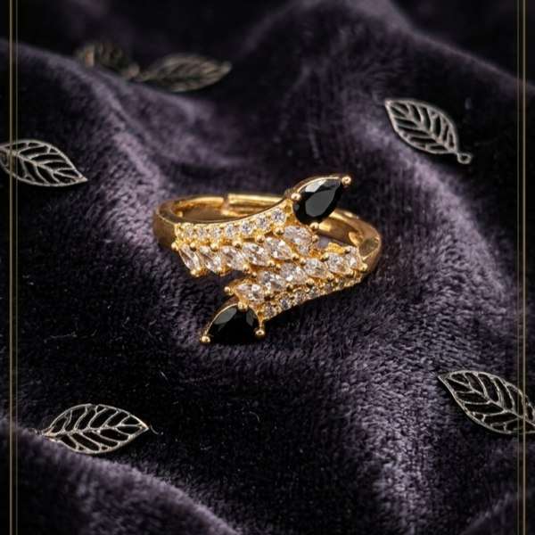 Luxury gold statement ring with marquise-cut clear crystals and black pear-shaped gemstones in a leaf-inspired design for women https://vastorastore.com/