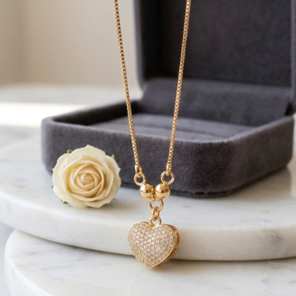 Luxury Gold Heart Pendant Necklace for Women with sparkling crystal heart charm on a gold-tone box chain by https://vastorastore.com/