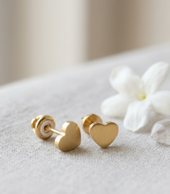 Luxury gold heart stud earrings with a brushed finish and secure screw-back closure for women by https://vastorastore.com/